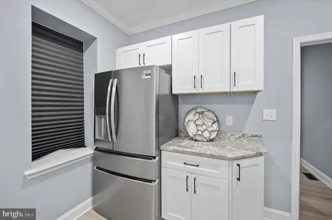 a kitchen with stainless steel appliances granite countertop a refrigerator and a stove