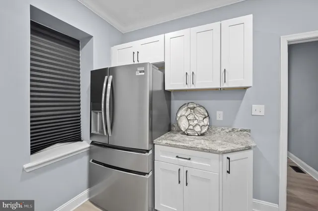 a kitchen with stainless steel appliances granite countertop a refrigerator and a stove