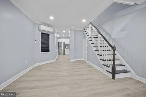 a view of an empty room with wooden floor