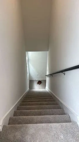 a white toilet sitting next to a white wall