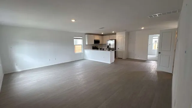 a view of a kitchen with a sink and a refrigerator