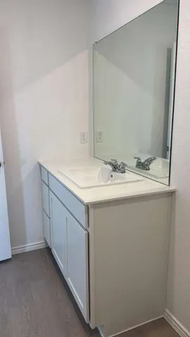 a kitchen with stainless steel appliances granite countertop a sink a stove and a refrigerator with wooden floor