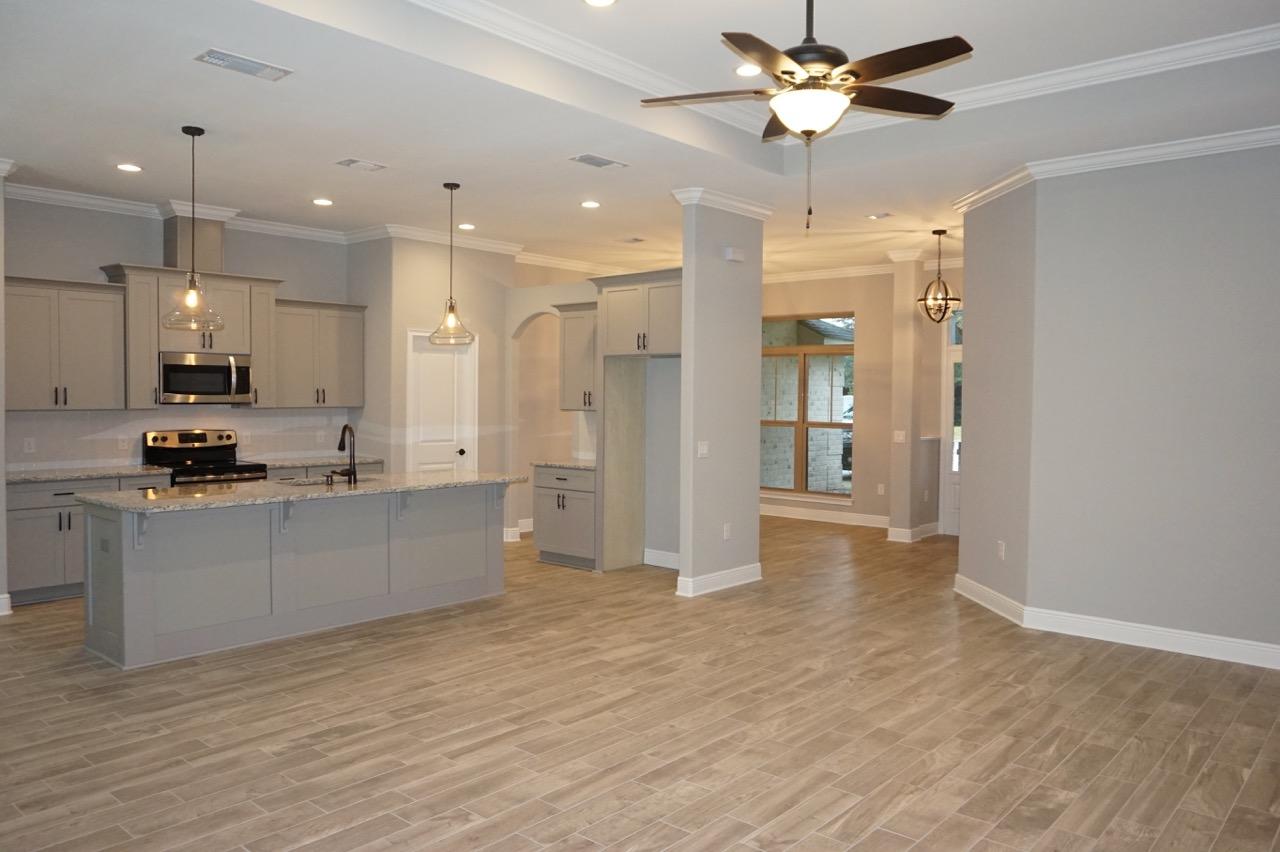 a view of kitchen with refrigerator stove and a chandelier
