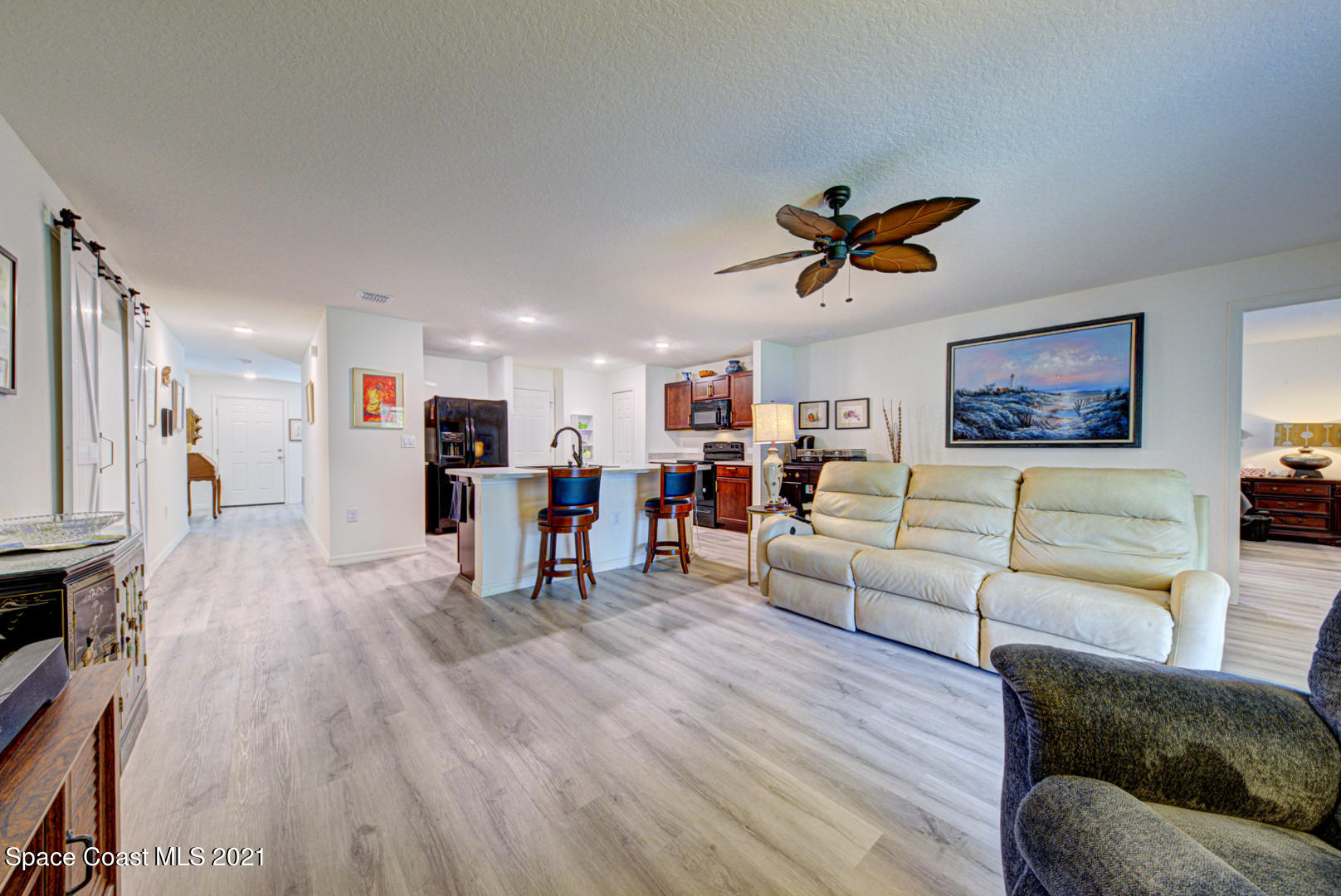 999 Commerce Road Southeast Palm Bay, FL 32909 - Photo 23 of 48 family room open to kitchen