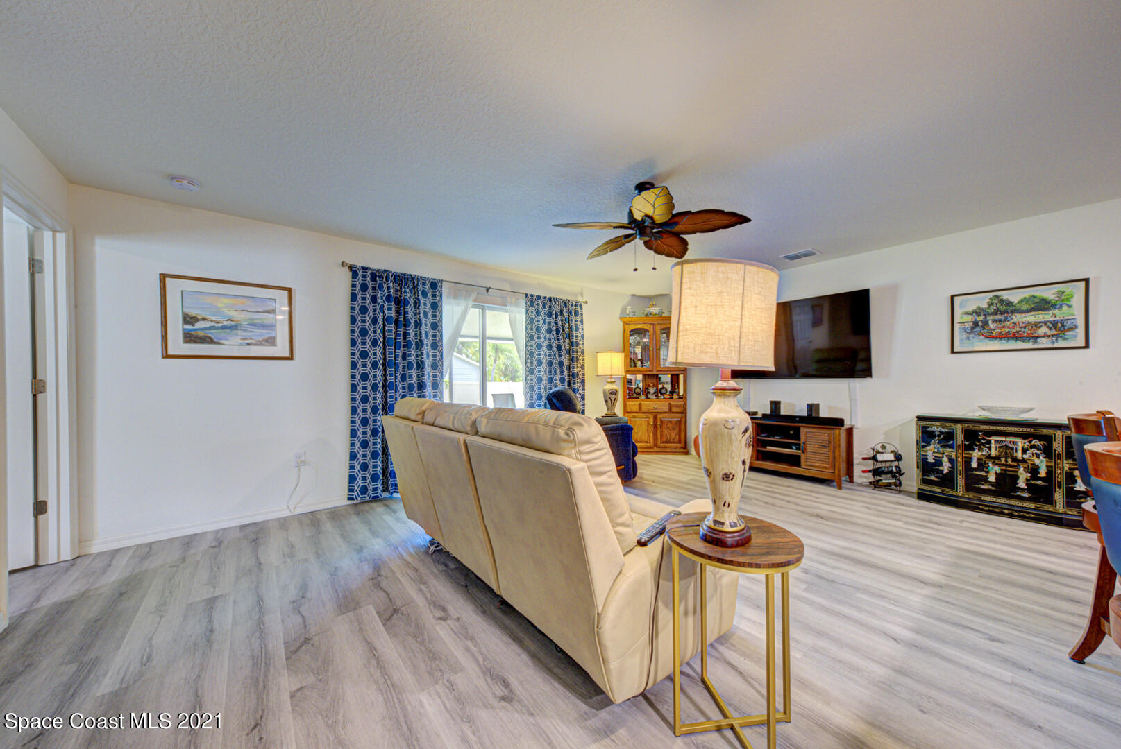 999 Commerce Road Southeast Palm Bay, FL 32909 - Photo 26 of 48 family room with sliders to porch