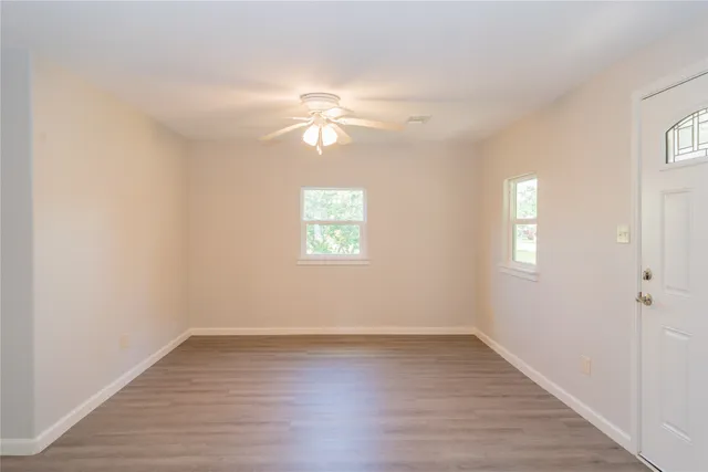 wooden floor in an empty room with a window