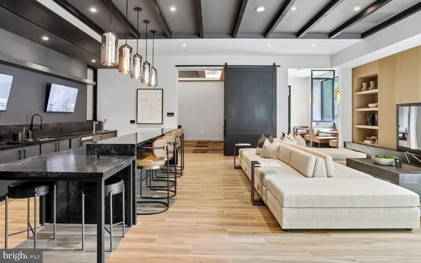 a living room with stainless steel appliances granite countertop furniture and a kitchen view