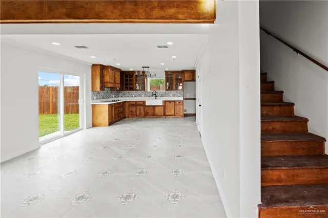 a view of kitchen and hall with wooden floor