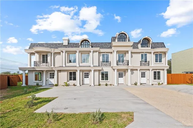 a front view of residential houses with yard