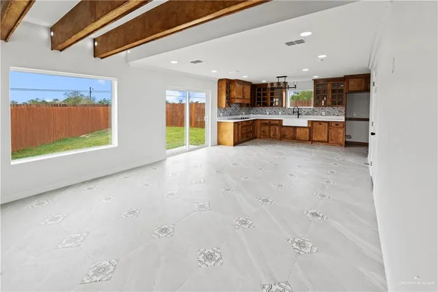 a open kitchen with stainless steel appliances kitchen island a large counter top space and cabinets