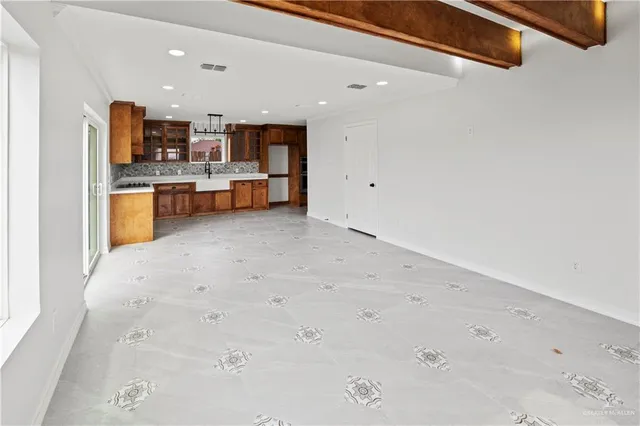a view of kitchen with refrigerator sink and stove