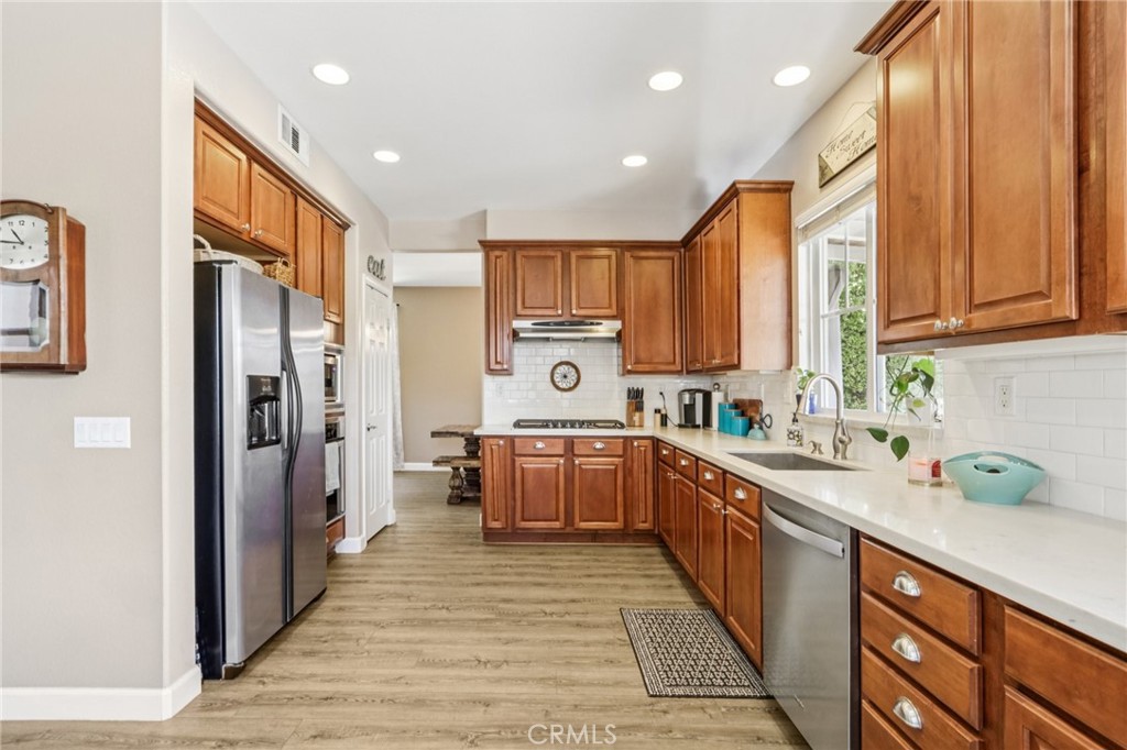 19941 Christopher Lane Saugus, CA 91350 - Photo 16 of 34 a kitchen with a sink refrigerator and cabinets