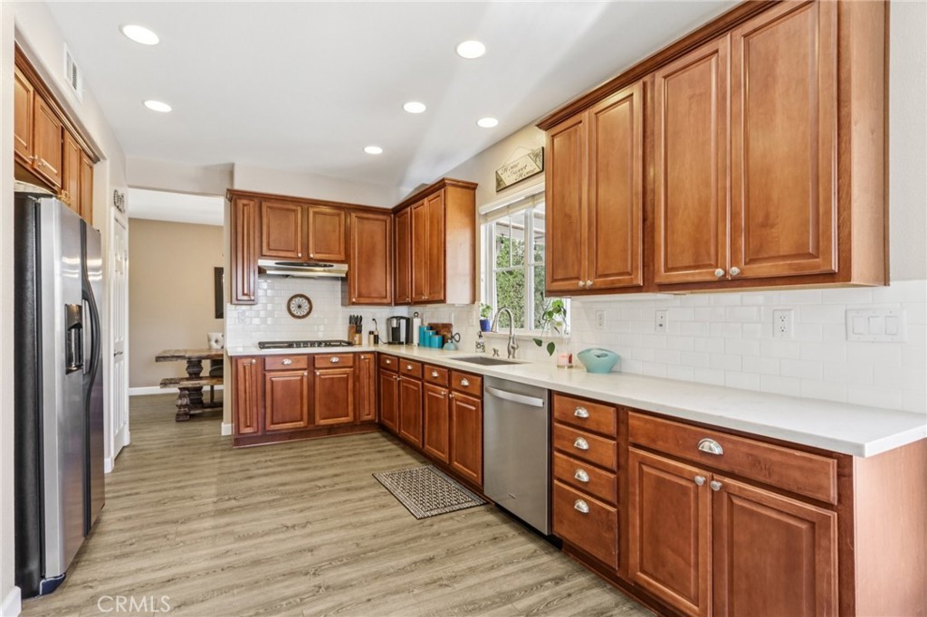 19941 Christopher Lane Saugus, CA 91350 - Photo 18 of 34 a kitchen with stainless steel appliances granite countertop a refrigerator sink and cabinets