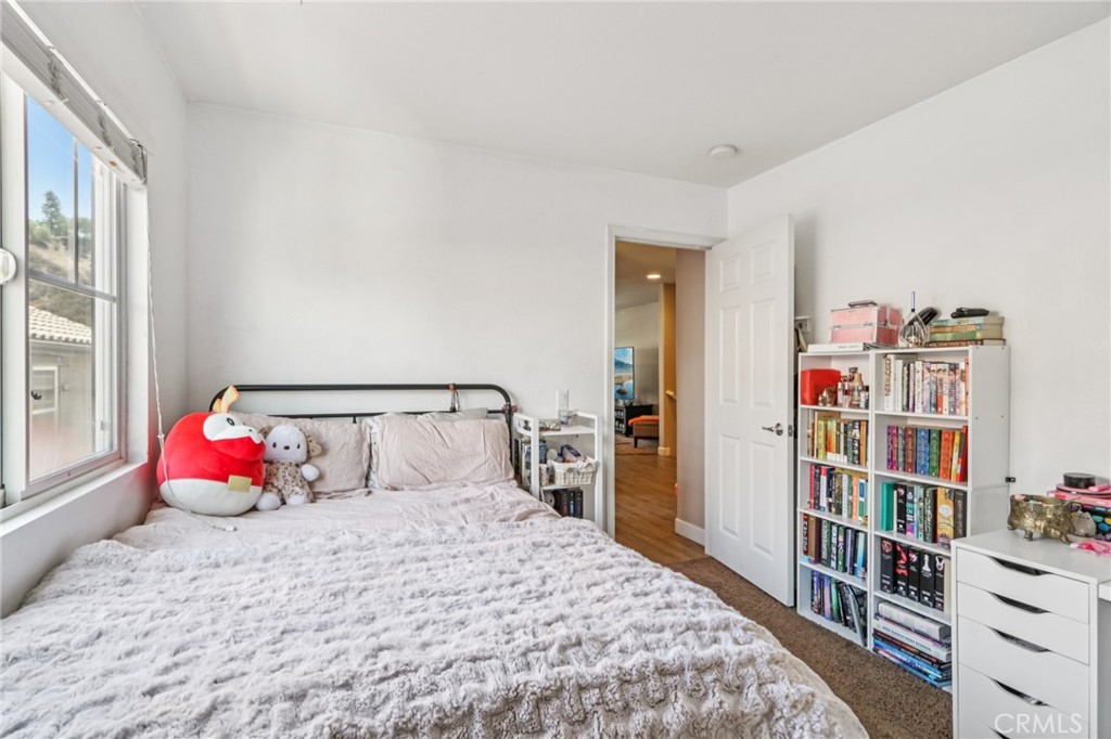 19941 Christopher Lane Saugus, CA 91350 - Photo 27 of 34 a bedroom with a bed and a book shelf