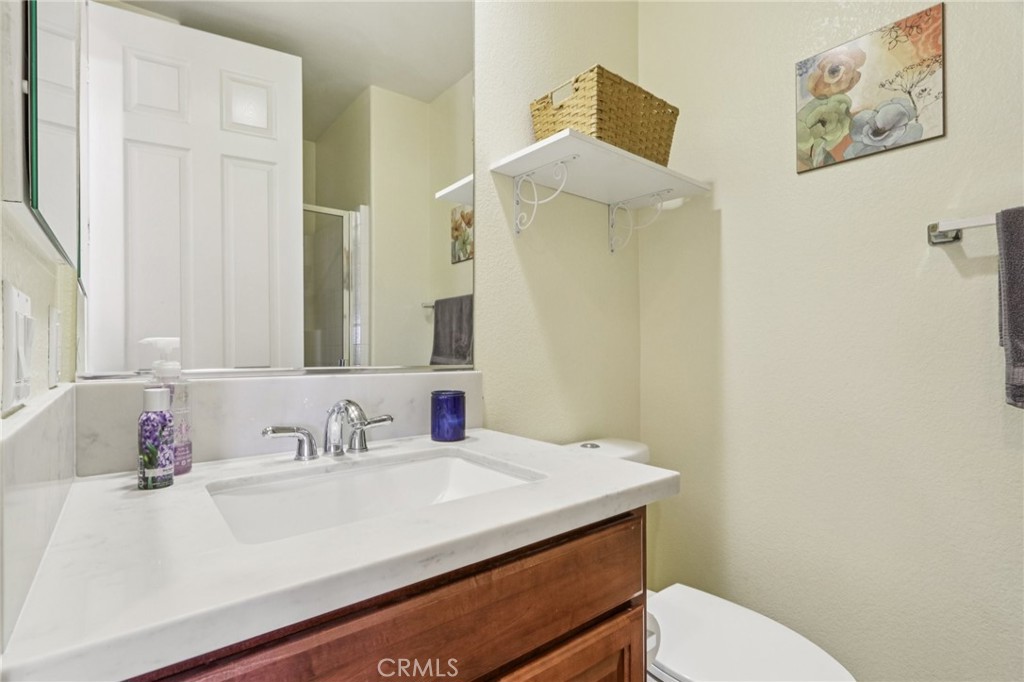19941 Christopher Lane Saugus, CA 91350 - Photo 28 of 34 a bathroom with a sink vanity mirror and toilet