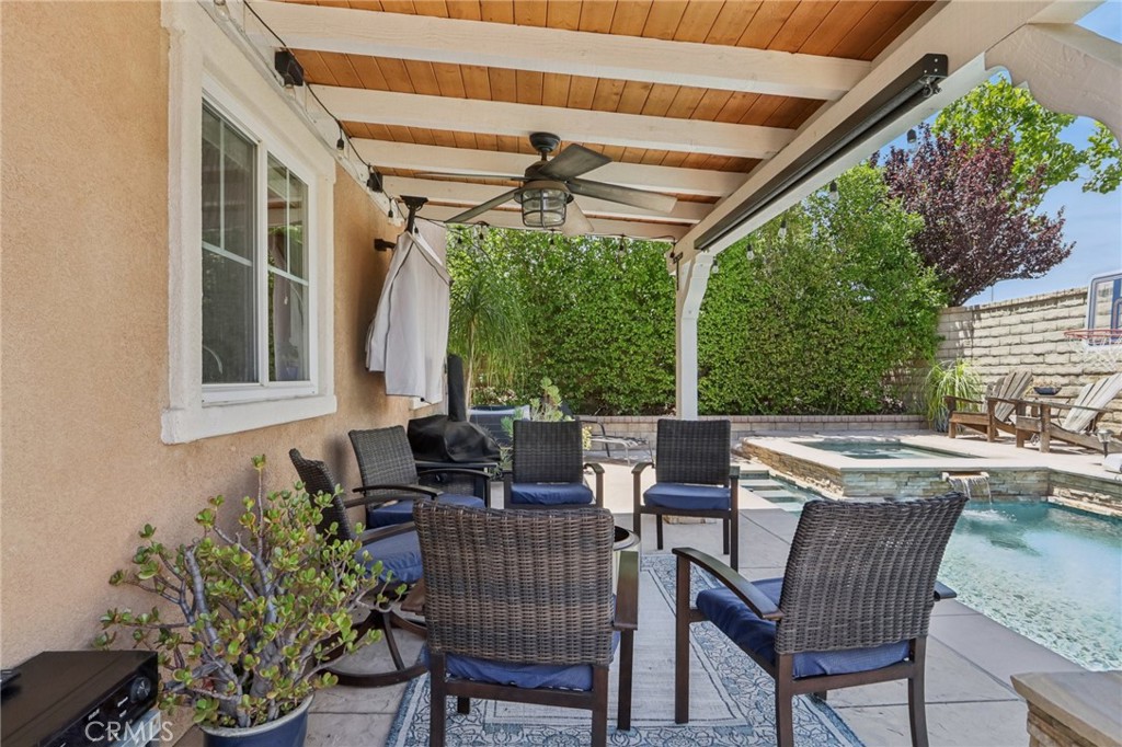19941 Christopher Lane Saugus, CA 91350 - Photo 33 of 34 a view of a patio with table and chairs and potted plants
