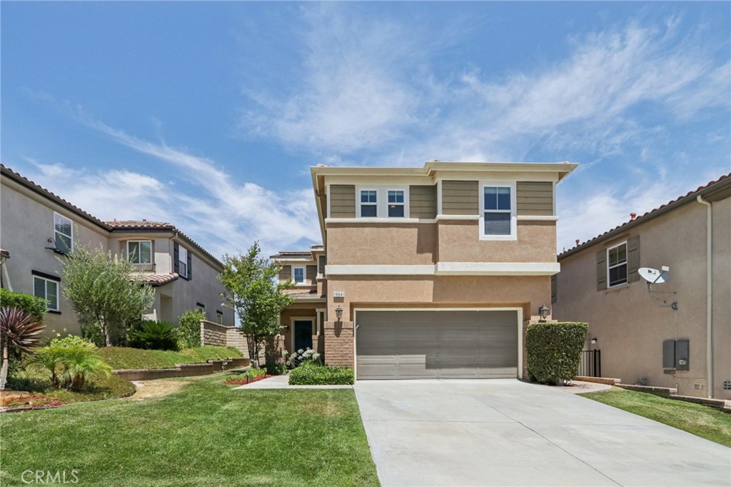 19941 Christopher Lane Saugus, CA 91350 - Photo 4 of 34 a front view of a house with a yard and garage