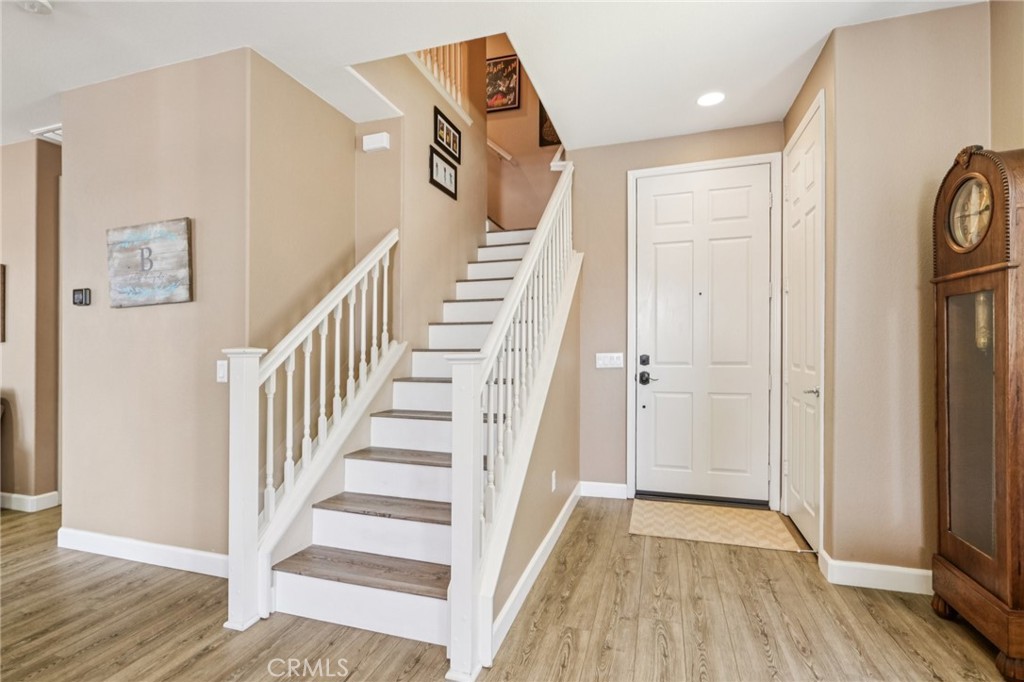 19941 Christopher Lane Saugus, CA 91350 - Photo 7 of 34 a view of a hallway with wooden floor and entryway