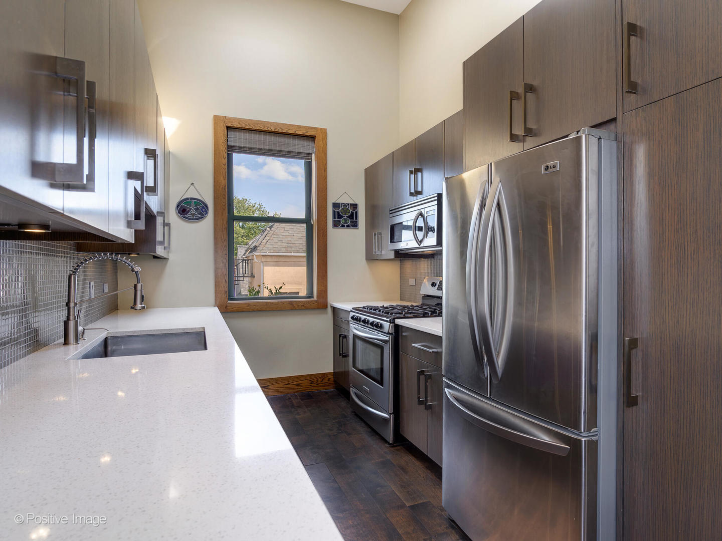 2543 North Racine Avenue, Unit 3N Chicago, IL 60614 - Photo 14 of 25 a kitchen with granite countertop a refrigerator and a sink
