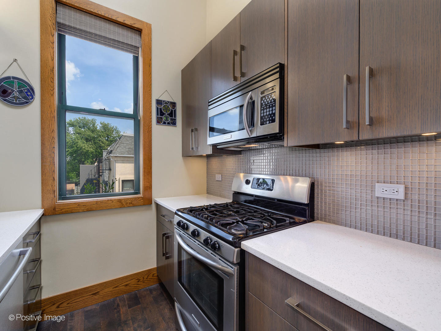2543 North Racine Avenue, Unit 3N Chicago, IL 60614 - Photo 16 of 25 a kitchen with stainless steel appliances a stove a microwave and cabinets