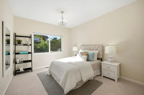 a bedroom with a large bed and a window