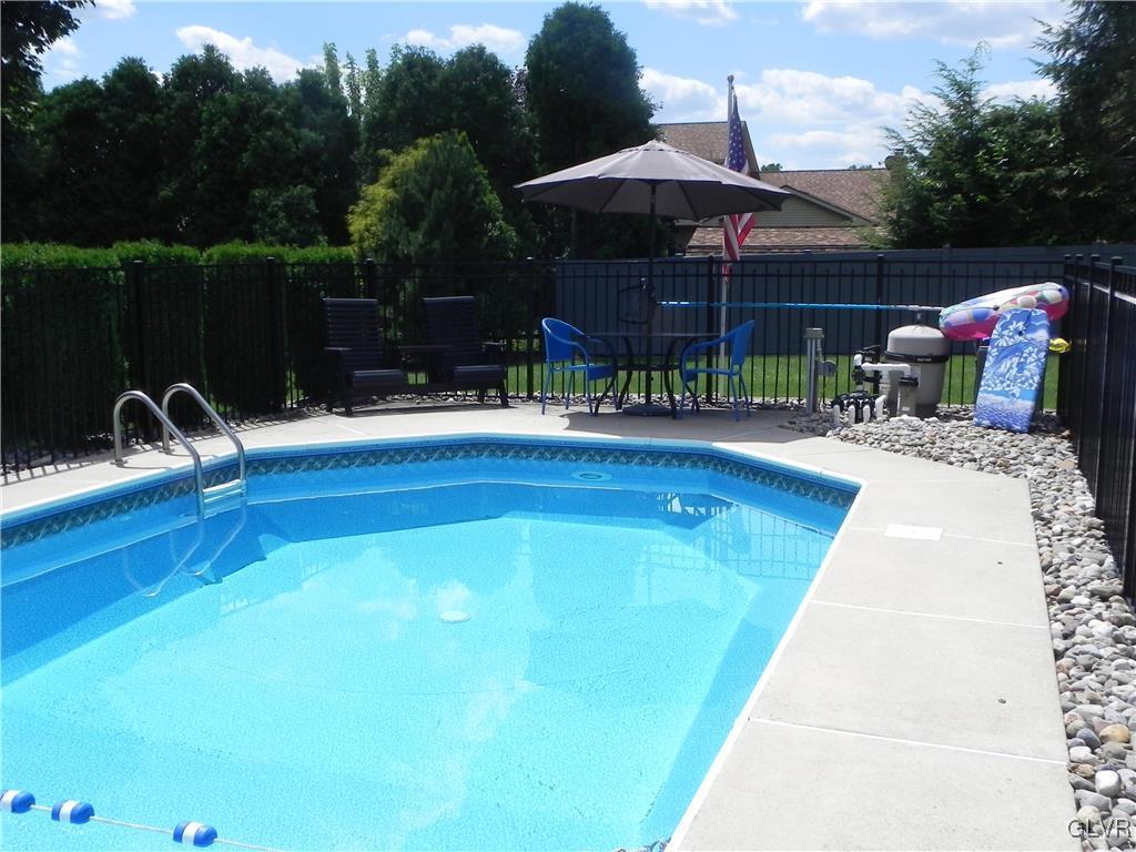 212 Ridgewood Road Easton, PA 18045 - Photo 38 of 44 a view of swimming pool with seating space and trees in the background