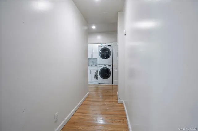 a walk in closet with wooden floor