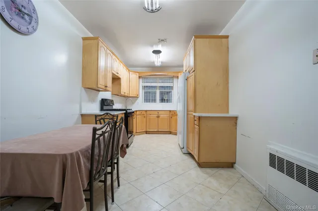 a view of kitchen with furniture and a refrigerator