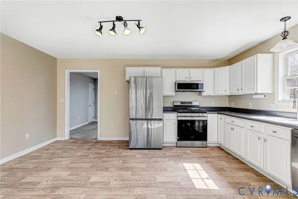 a kitchen with a refrigerator stove and microwave