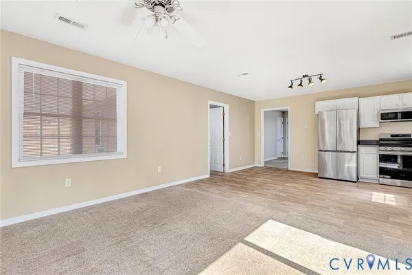 a kitchen with granite countertop white cabinets and stainless steel appliances