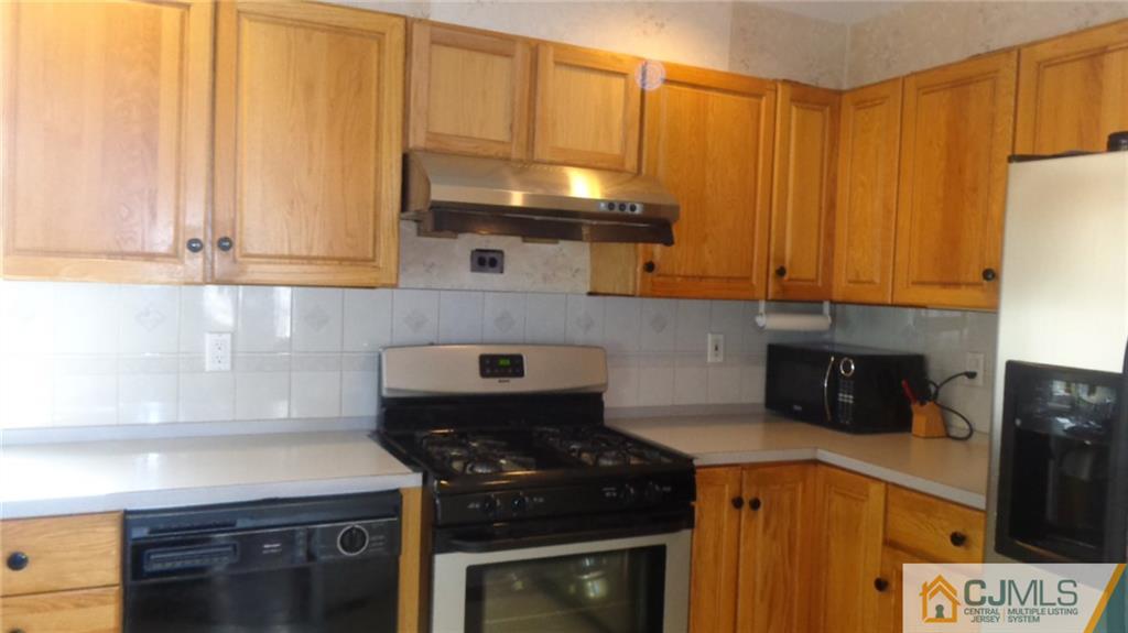 34 Brandywine Road Fords, NJ 08863 - Photo 7 of 19 a kitchen with stainless steel appliances a stove a microwave and cabinets
