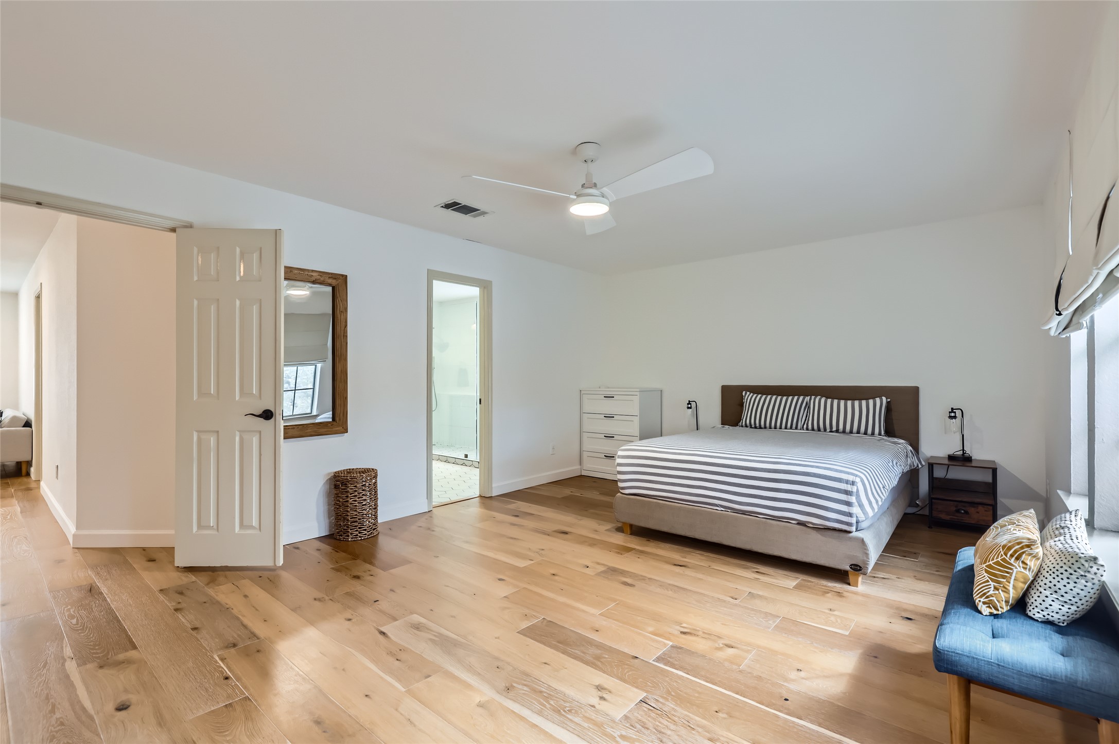 13205 Kepler Cove Austin, TX 78729 - Photo 17 of 34 a spacious bedroom with a bed and a couch