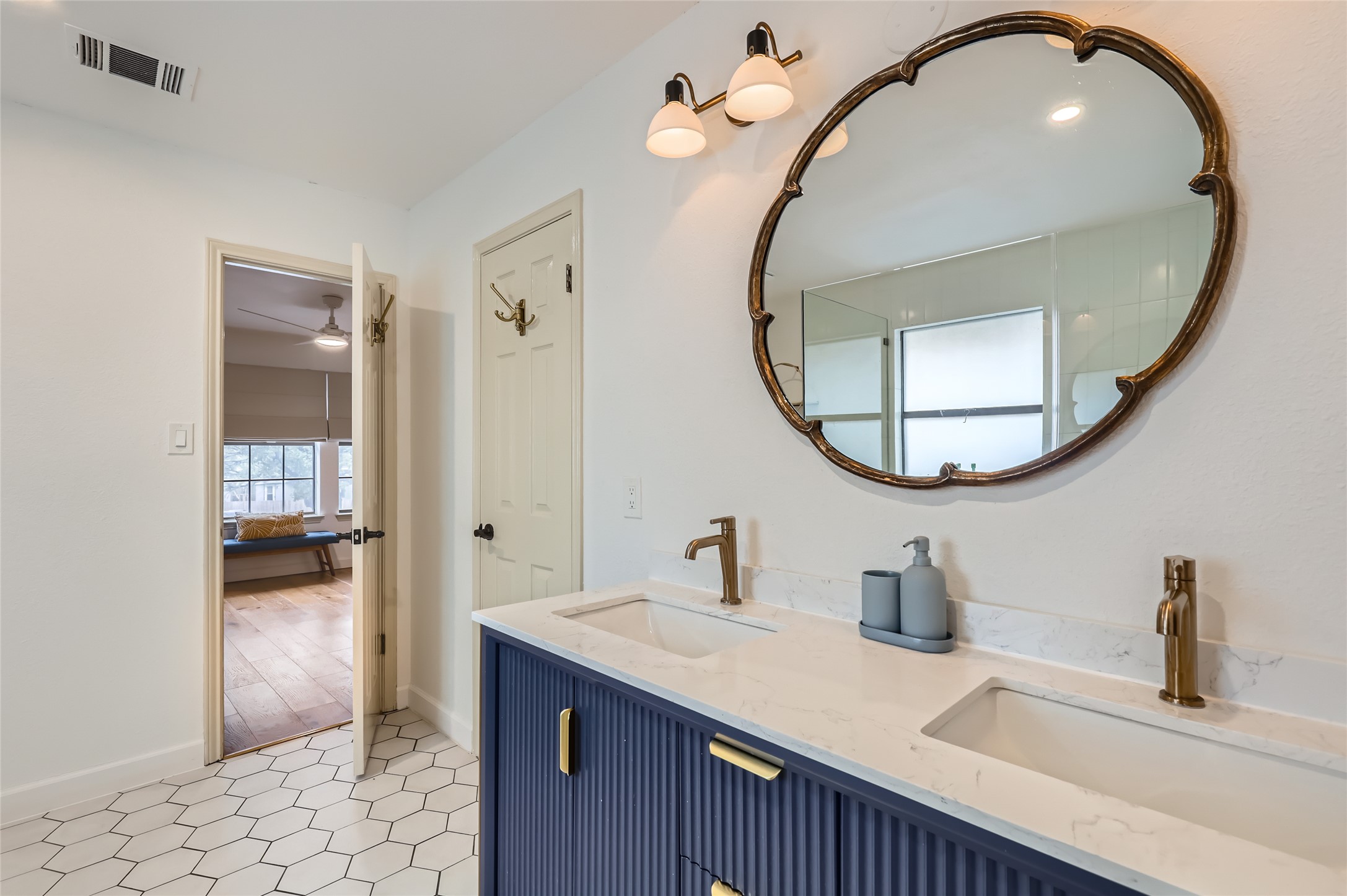 13205 Kepler Cove Austin, TX 78729 - Photo 18 of 34 a bathroom with a sink a vanity and a mirror