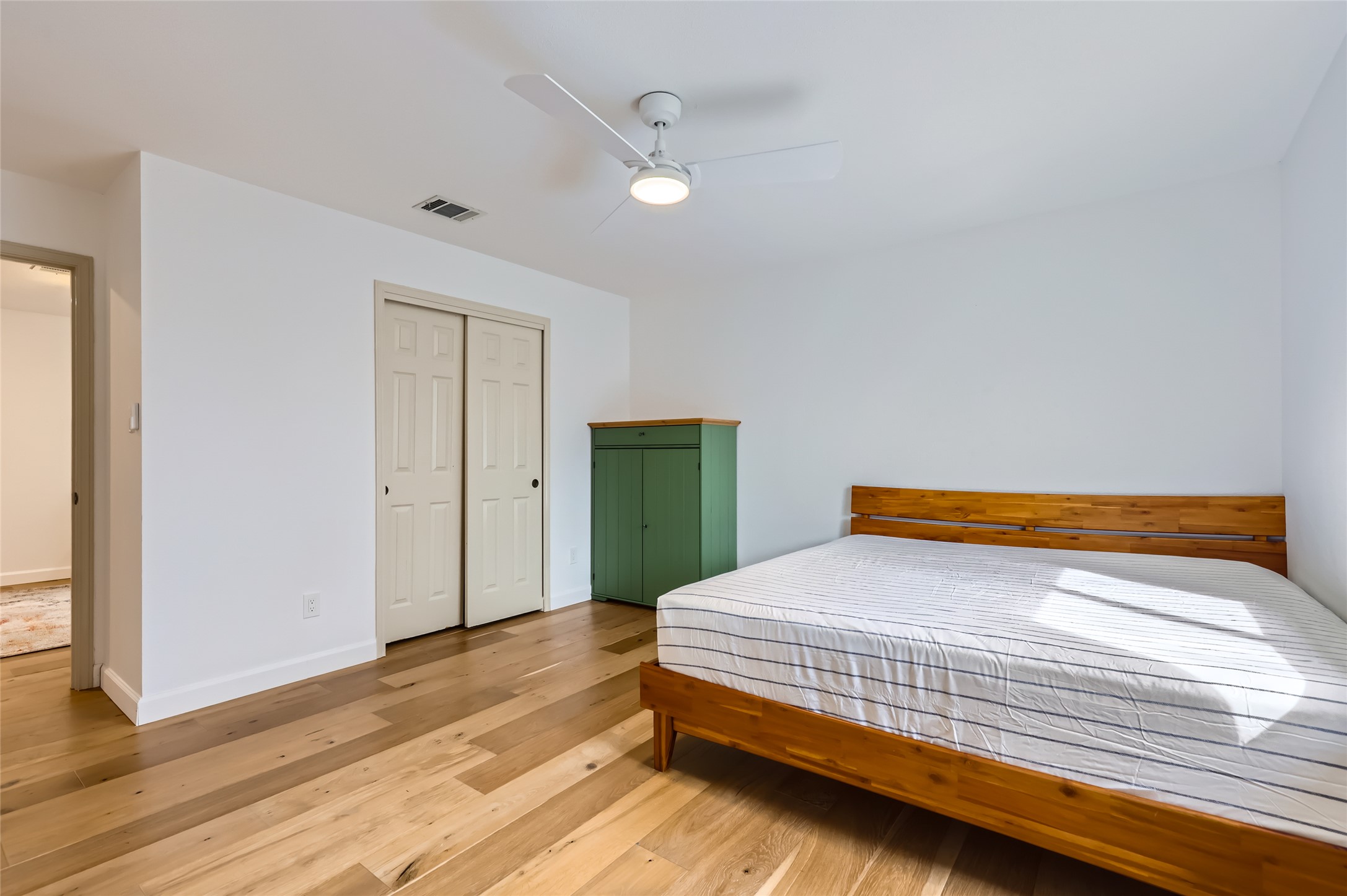 13205 Kepler Cove Austin, TX 78729 - Photo 21 of 34 a bedroom with a bed and a mirror
