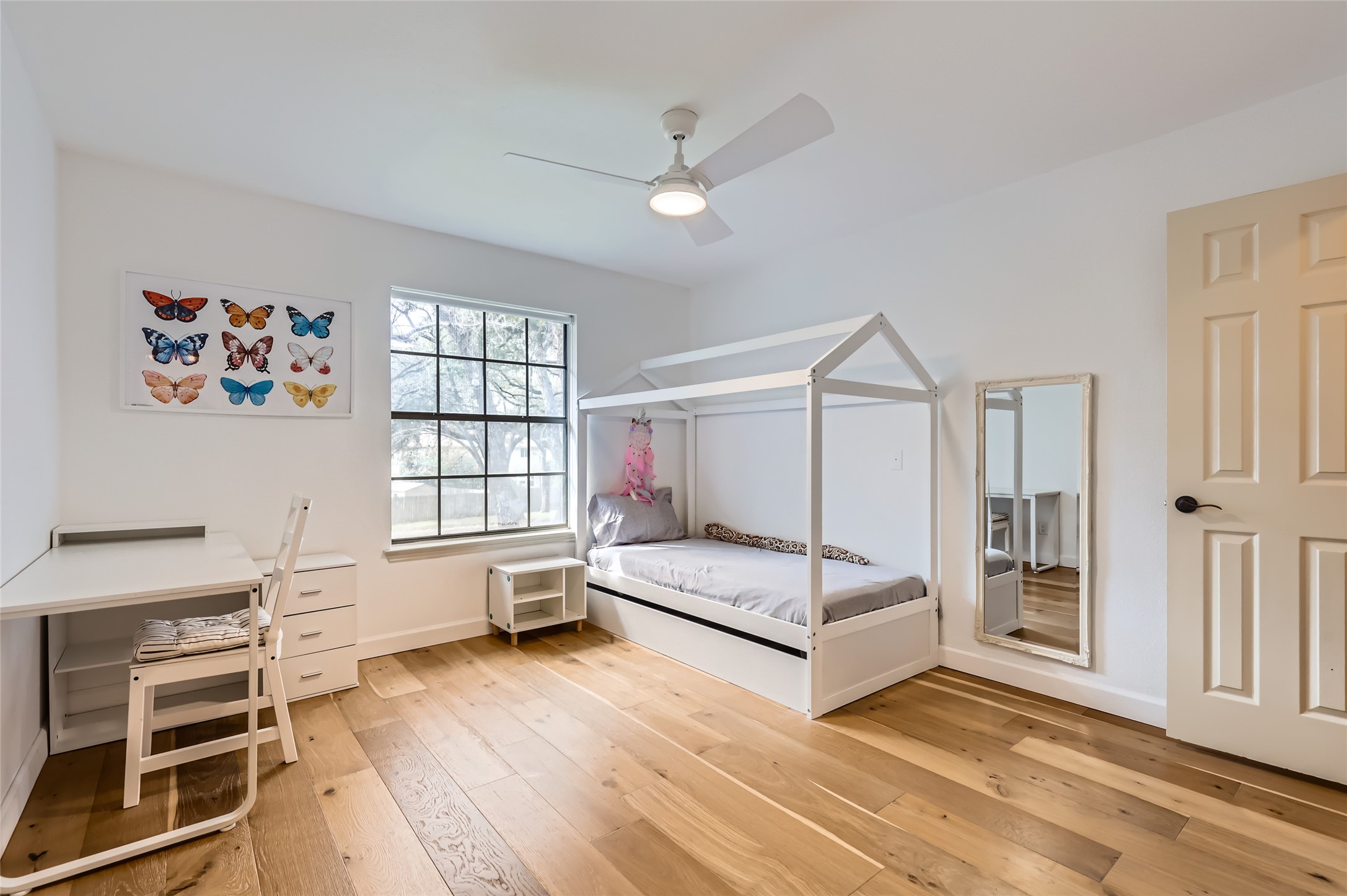 13205 Kepler Cove Austin, TX 78729 - Photo 24 of 34 a spacious bedroom with a bed and a window