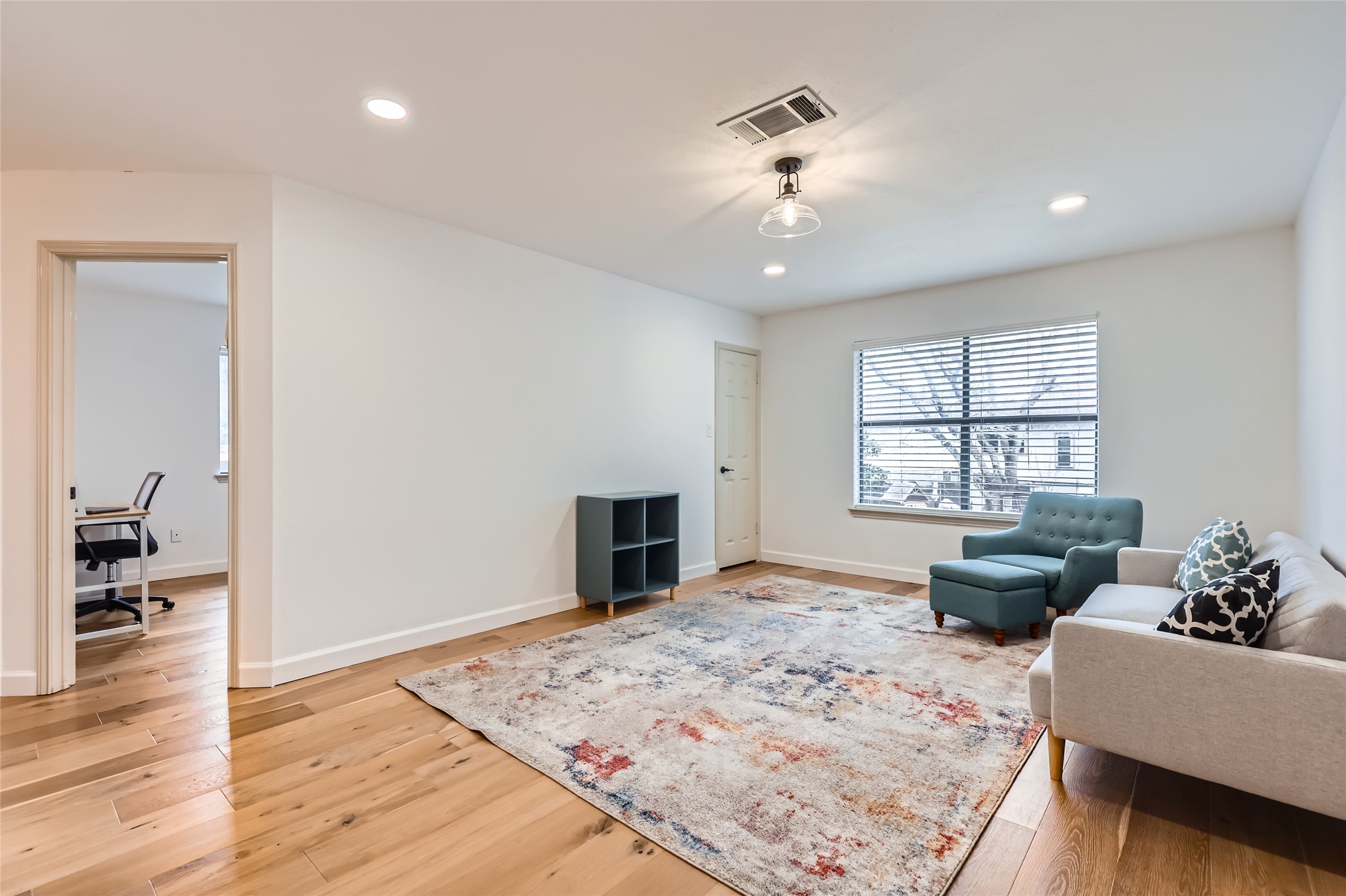 13205 Kepler Cove Austin, TX 78729 - Photo 27 of 34 a living room with furniture windows and a wooden floor
