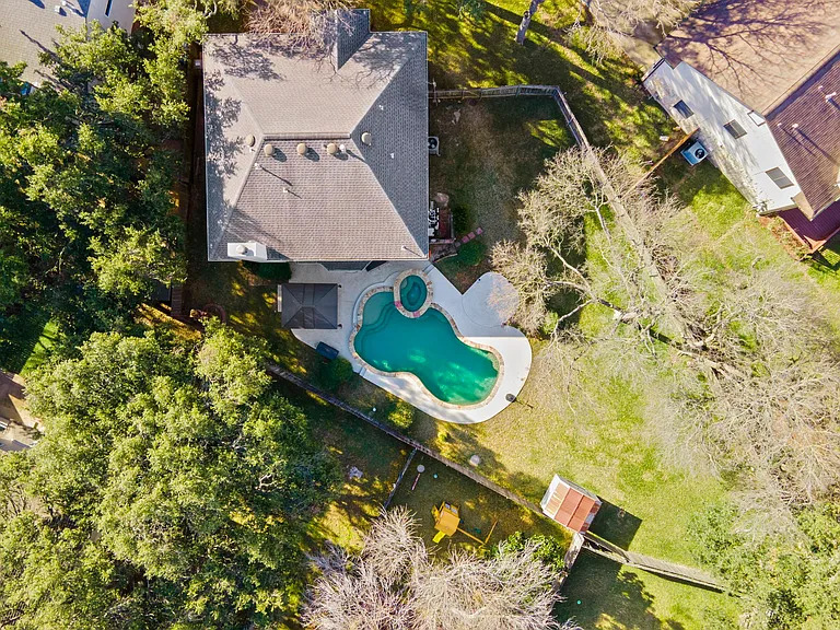 13205 Kepler Cove Austin, TX 78729 - Photo 34 of 34 an aerial view of a house with swimming pool and large trees