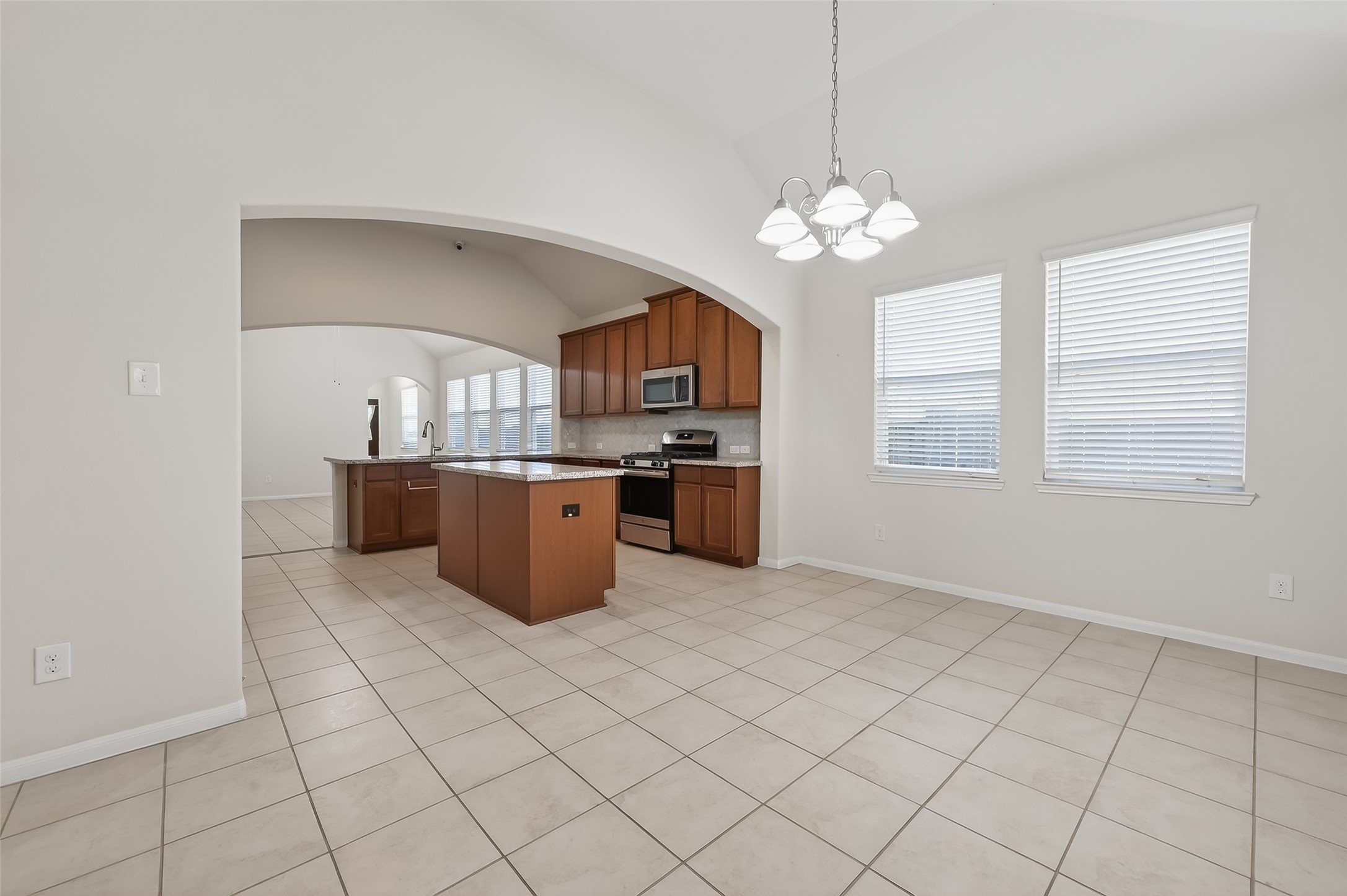 7631 Granite Terrace Lane Houston, TX 77083 - Photo 12 of 46 a kitchen with stainless steel appliances granite countertop a stove a sink and a refrigerator