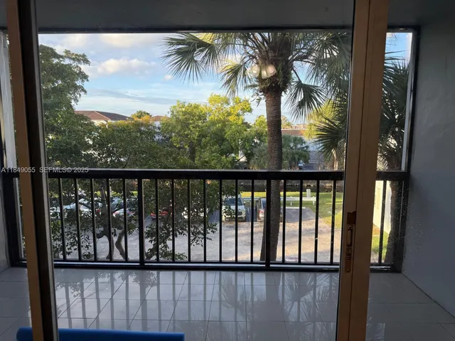 a view of a balcony with a forest