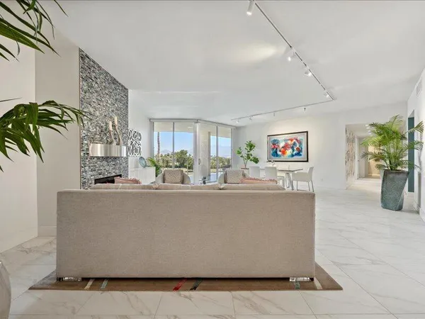 a living room with furniture and a potted plant