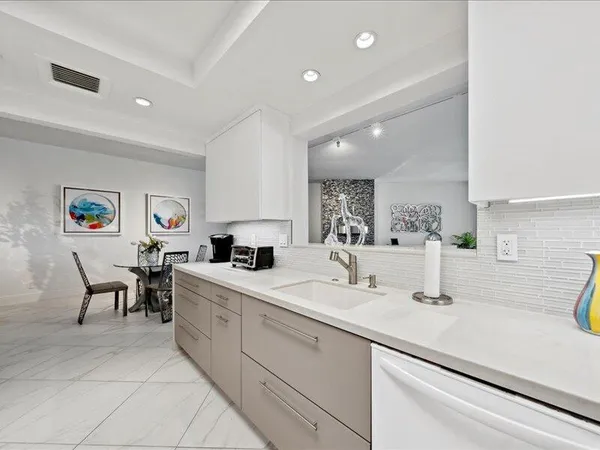 a kitchen with a sink and chairs