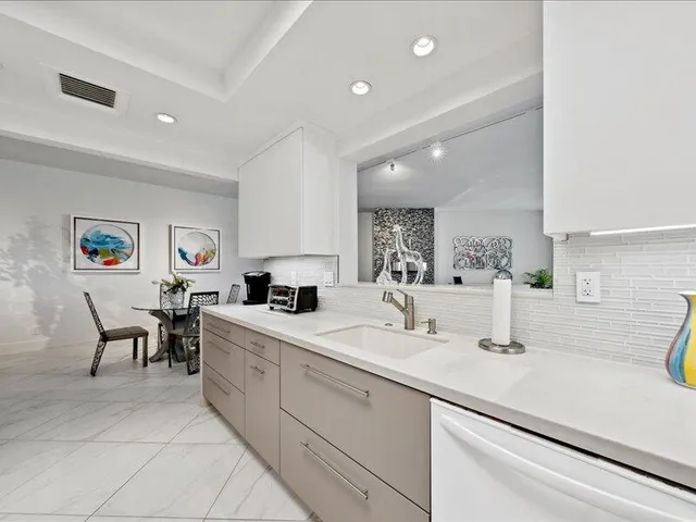 a kitchen with a sink and chairs