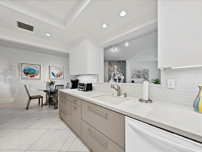 900 Island Drive, Unit 503 Rancho Mirage, CA 92270 - Photo 20 of 31 a kitchen with a sink and chairs