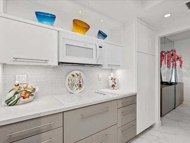 a kitchen with stainless steel appliances granite countertop a sink and a microwave