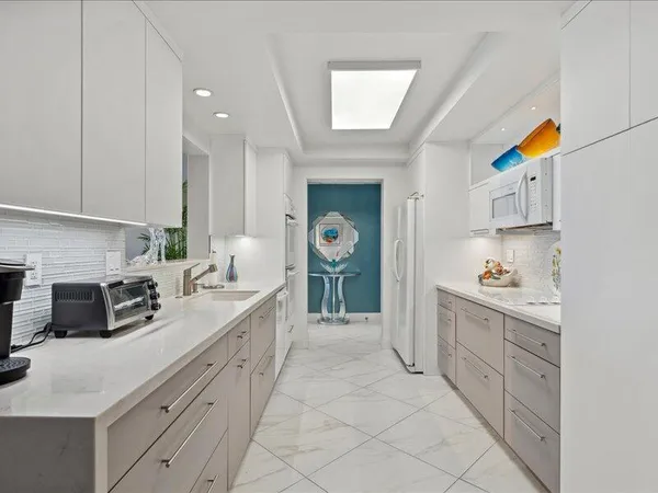 a kitchen with cabinets and window