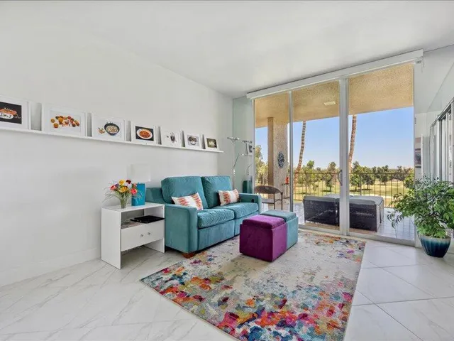 a living room with furniture and a floor to ceiling window