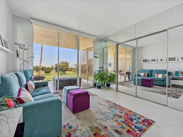 a living room with furniture and a floor to ceiling window