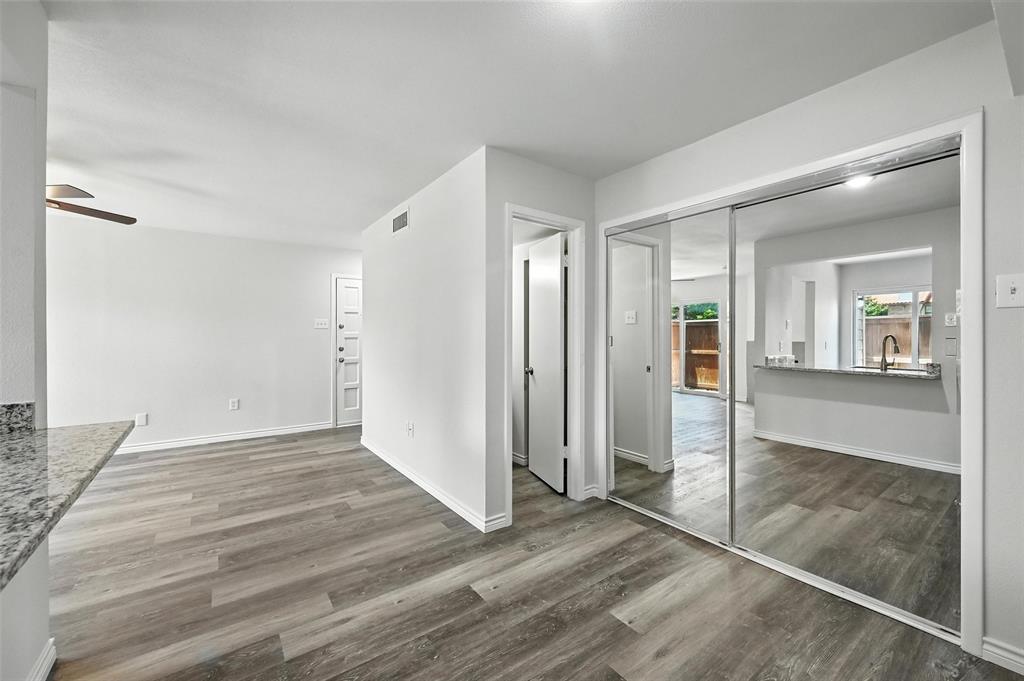 5626 Preston Oaks Road, Unit 22C Dallas, TX 75254 - Photo 13 of 29 an empty room with wooden floor and a bathroom