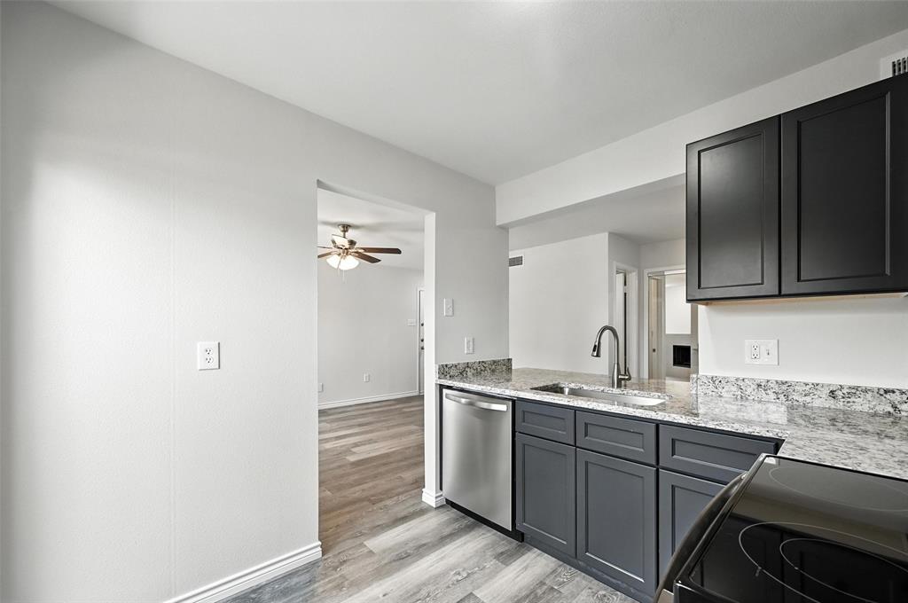 5626 Preston Oaks Road, Unit 22C Dallas, TX 75254 - Photo 16 of 29 a kitchen with a sink cabinets and wooden floor