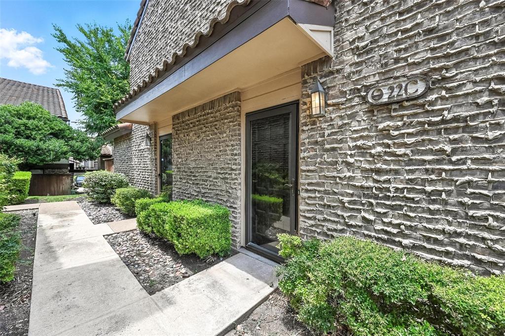 5626 Preston Oaks Road, Unit 22C Dallas, TX 75254 - Photo 2 of 29 a front view of a house with garden